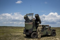 Spc. Christopher Bazan and Sgt. John Akins, Florida National Guard 3rd Battalion, 265 Air Defense Artillery Regiment, talk over their plan of action April 20.  The unit along with the Army’s Stinger Based Systems used the Eglin Air Force Base range to test fire stinger missiles from the vehicle. (U.S. Air Force photo/Samuel King Jr.)