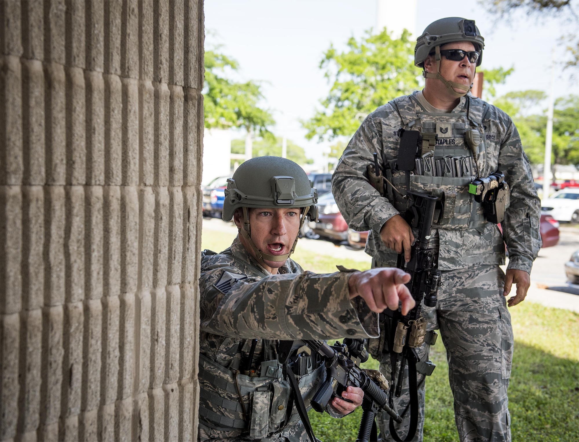 Master Sgt. Shane Zugai, 96th Security Forces Squadron, yells orders to Airmen prior to entering a building during an active shooter exercise at Eglin Air Force Base, Fla., April 11.  The goal of the exercise was to evaluate people’s knowledge and response at the active shooter location and select lockdown locations.  (U.S. Air Force photo/Samuel King Jr.)