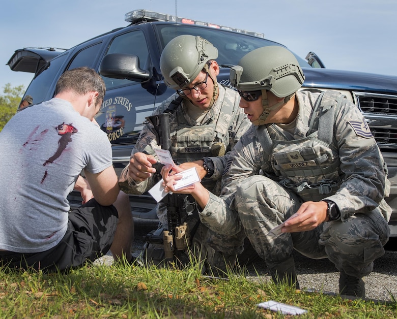 Airmen from the 96th Security Forces Squadron sort through the simulated wounded victims’ information during an active shooter exercise at Eglin Air Force Base, Fla., April 11.  The goal of the exercise was to evaluate people’s knowledge and response at the active shooter location and select lockdown locations.  (U.S. Air Force photo/Samuel King Jr.)