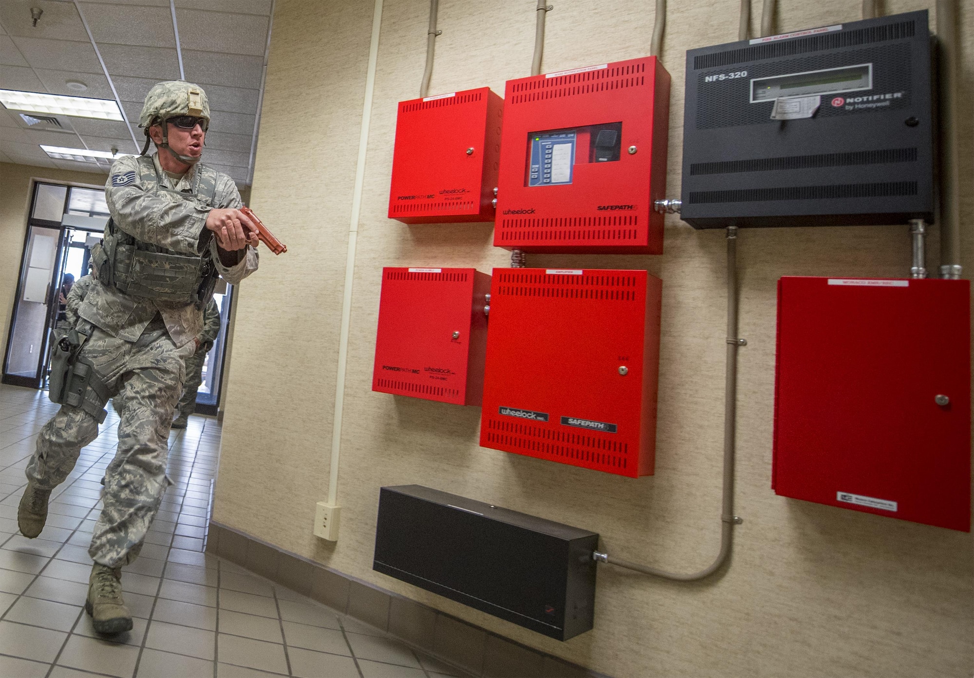 Tech. Sgt. Nathaniel Darling, 96th Security Forces Squadron, moves into the building looking for an armed gunman during an active shooter exercise at Eglin Air Force Base, Fla., April 11.  The goal of the exercise was to evaluate people’s knowledge and response at the active shooter location and select lockdown locations.  (U.S. Air Force photo/Samuel King Jr.)