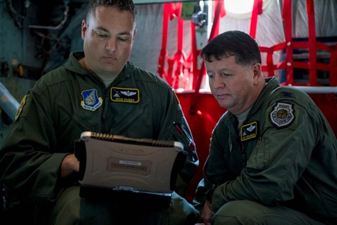 Maj. Jesse N. Barnes, 36th Airlift Squadron C-130 instructor navigator, and Col. Neil R. Richardson, 374th Airlift Wing vice commander, do a finial check of flight plans April 12, 2017, at Yokota Air Base, Japan. Richardson’s last flight, known as a “fini” flight, follows an Air Force tradition dating back to WWII where upon completion of an aircrew member’s final flight they are doused with water and congratulated by their comrades in arms and family. (U.S. Air Force photo by Airman 1st Class Donald Hudson)