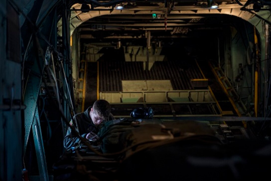 Airman 1st Class Christian Williams, 36th Airlift Squadron C-130H Hercules loadmaster, performs final checks on container delivery system bundles before takeoff April 12, 2017, at Yokota Air Base, Japan. The training exercise was also Col. Neil R. Richardson, 374th Airlift Wing vice commanders, “fini” flight. (U.S. Air Force photo by Airman 1st Class Donald Hudson)