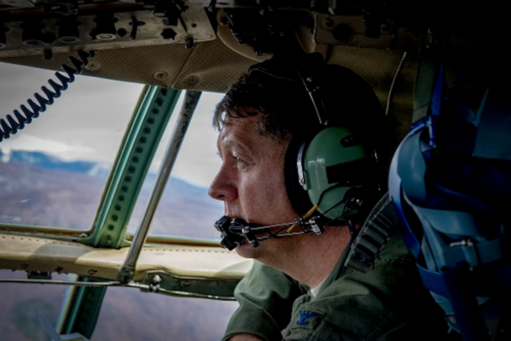 Col. Neil R. Richardson, 374th Airlift Wing vice commander, looks out window of C-130H Hercules during his “fini” flight, April 12, 2017, over mainland Japan. Richardson is a C-130E/H Hercules master navigator and former U.S. Air Force Weapons Instructor Cadre. (U.S. Air Force photo by Airman 1st Class Donald Hudson)