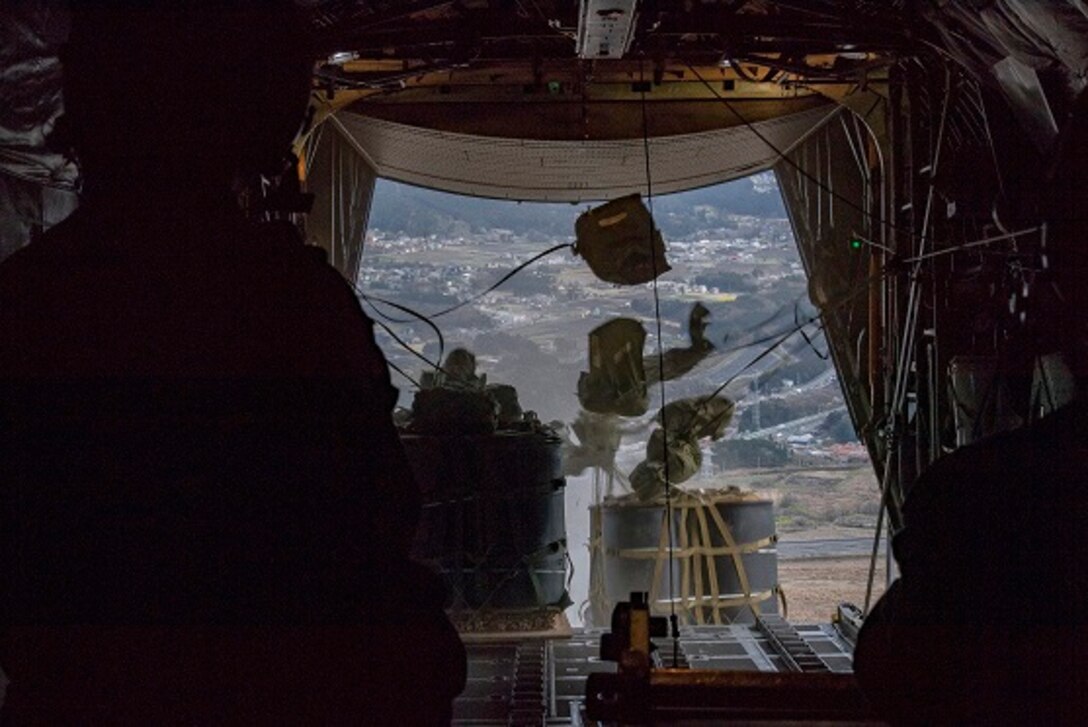 A mass container delivery system bundle drop leaves cargo bay of C-130H Hercules April 12, 2017, over Combined Armed Training Center Camp Fuji, Japan. The training exercise was also Col. Neil R. Richardson, 374th Airlift Wing vice commanders, “fini” flight. (U.S. Air Force photo by Airman 1st Class Donald Hudson)