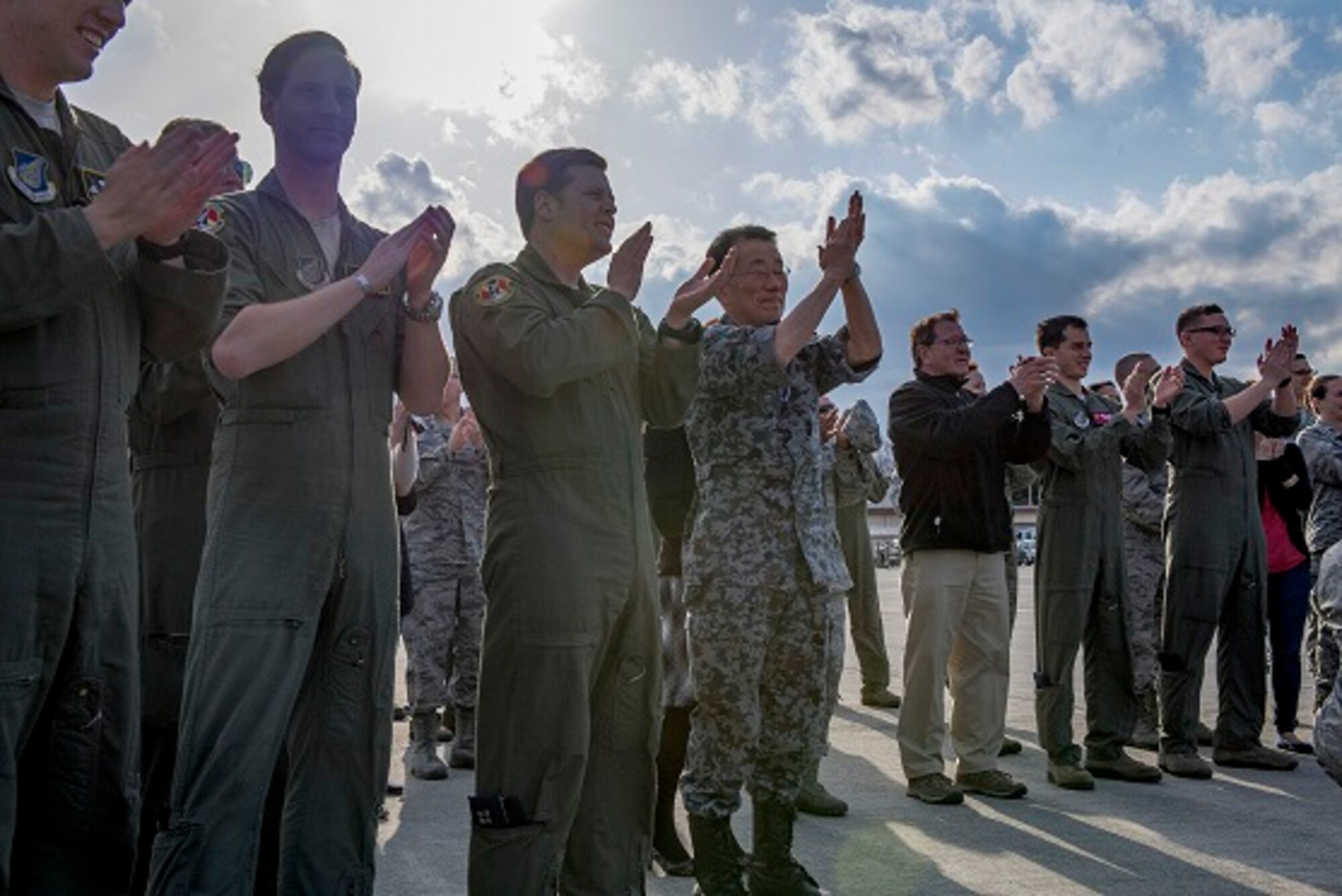 Crowd members applaud for Col. Neil R. Richardson, 374th Airlift Wing vice commander, during his traditional “fini” flight, ceremony April 12, 2017, at Yokota Air Base, Japan. Richardson is scheduled to leave Yokota to become commander of the 87th Air Base Wing at Joint Base McGuire-Dix-Lakehurst. (U.S. Air Force photo by Airman 1st Class Donald Hudson)