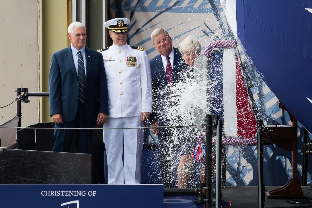 Vice President Mike Pence, left, looks on as Diane Donald christens the Virginia-class submarine, the future USS Indiana, at Newport News, Va., April 29, 2017. Also on hand are Navy Cdr. Jesse Zimbauer, the submarine's commanding officer, and Newport News Shipbuilding President Matt Mulherin. Navy photo by Ashley Major courtesy Huntington Ingalls Industries