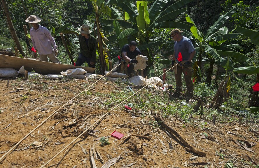 U.S. Army Sergeant First Class, Taylor, Defense POW/MIA Accountability Agency team sergeant, places a sand bag on the edge of a digging unit to ensure all of the excavated dirt stays within the unit in Phuoc Son providence, Vietnam, May 22, 2017. Since 1973, the remains of more than 1,000 Americans killed in the Vietnam War have been identified and returned to their families for a proper burial with full military honors.(U.S. Air Force photo by Staff Sgt. David Owsianka) 