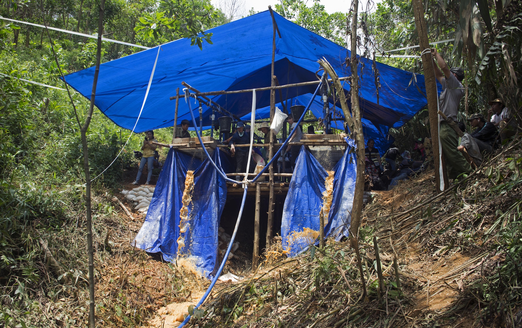 U.S. Service members and Vietnamese personnel take a break near the wet screening station after searching for a fallen service member from the Vietnamese War in Phuoc Son providence, Vietnam, May 27, 2017. The mission of DPAA is to provide the fullest possible accounting for our missing personnel to their families and their nation. (U.S. Air Force photo by Staff Sgt. David Owsianka) 