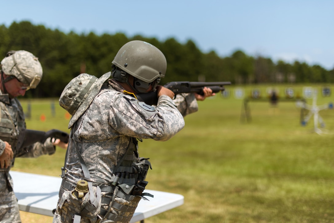 A guardsman prepares to fire a pump-action shotgun at targets while competing in the 46th Winston P. Wilson Championships at the National Guard Marksmanship Training Center in North Little Rock, Ark., July 24, 2017. Army photo by Staff Sgt. Jeremiah Runser