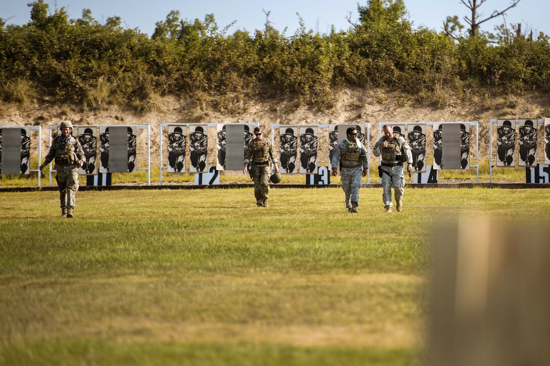 Guardsmen return to firing positions after checking targets while competing in the 46th Winston P. Wilson Championships at the National Guard Marksmanship Training Center in North Little Rock, Ark., July 25, 2017. Army photo by Staff Sgt. Jeremiah Runser