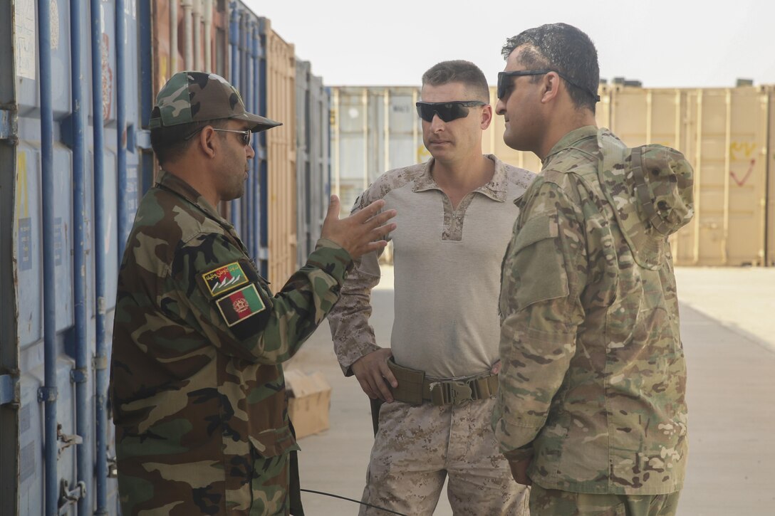 An Afghan National Army soldier with the Helmand Province Regional Military Training Center speaks with a U.S. Marine advisor assigned to Task Force Southwest during a gear inventory at Camp Shorabak, Afghanistan, July 30, 2017. Instructors with the RMTC are working with their Marine counterparts during a four-week train-the-trainer course to improve the efficiency and effectiveness of the operational readiness cycle, which teaches ANA soldiers infantry skills and tactics. (U.S. Marine Corps photo by Sgt. Lucas Hopkins)