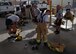 Airmen hustle to don protective equipment during Fire Immersion Training July 28, 2017, Al Dhafra Air Base, United Arab Emirates. Airmen were given one minute, the maximum limit for firefighters, to don all their personal protective equipment as part of a bunker drill. (U.S. Air Force photo by Senior Airman Preston Webb)