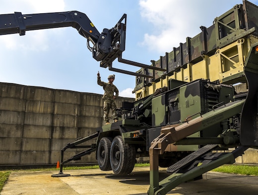 U.S. Army Spc. Justin Maurer Alpha Battery, 2nd Battalion, 1st Air Defense Artillery Regiment patriot missile operator and maintainer, guides a fork lift while maneuvering dummy munitions on a patriot missile system at Kunsan Air Base, Republic of Korea, July 27, 2017. Maurer took part in a week-long field training exercise that included proper 24-hour manning and changeover for crew operations, Patriot Launcher reloads, and Operational Readiness Evaluations. (U.S. Air Force photo by Senior Airman Michael Hunsaker/Released).