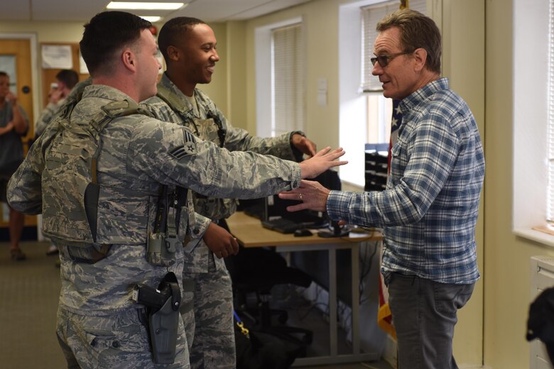 Hollywood actor Bryan Cranston is “apprehended” by Airmen assigned to the 48th Security Forces Squadron at Royal Air Force Lakenheath, England, July 29. Cranston was pretend arrested by the 48th SFS to paint a picture of just one part of the responsibilities of the squadron. (U.S. Air Force photo/Airman 1st Class Eli Chevalier) 