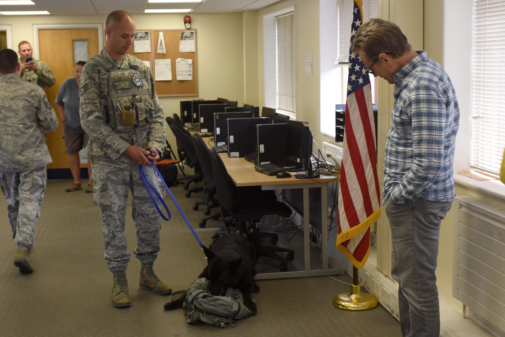 Hollywood actor Bryan Cranston is “apprehended” by Airmen assigned to the 48th Security Forces Squadron at Royal Air Force Lakenheath, England, July 29. Cranston was pretend arrested by the 48th SFS to paint a picture of just one part of the responsibilities of the squadron. (U.S. Air Force photo/Airman 1st Class Eli Chevalier) (Portions of this image have been blurred to protect operational security)