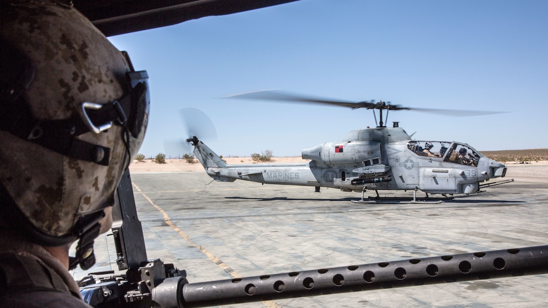 U.S. Marine Corps Staff Sgt. Ryan D. Peek, an aerial observer with Marine Light Attack Helicopter Squadron 167, Marine Air Ground Task Force 8 (MAGTF) observes an AH-1 Cobra landing after completion of a close air support drill during Integrated Training Exercise (ITX) 5-17 at Marine Corps Air Ground Combat Center, Twentynine Palms, Calif., July 21, 2017. The purpose of ITX is to create a challenging, realistic training environment that produces combat-ready forces capable of operating as an integrated MAGTF. (U.S. Marine Corps Photo by Sgt. Kassie L. McDole)
