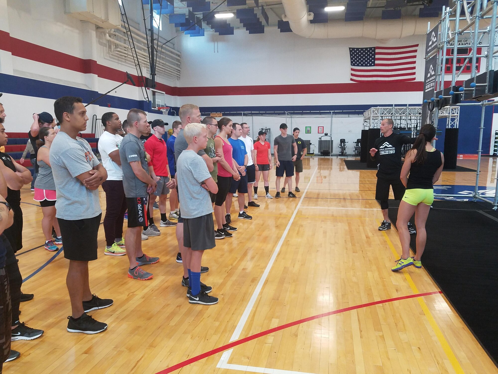 American Ninja Warrior champions Brent Steffensen and Rebekah Bonilla brief and demonstrate how to complete each Battle Rig station during the Air Force Alpha Warrior competition at Freedom Hall Fitness Center at F.E. Warren Air Force Base, Wyo. July 8, 2017. The Alpha Warrior Program is an Air Force-wide fitness initiative to incorporate a functional fitness approach in every Airman’s mindset and a way to tackle the four pillars of Comprehensive Airmen Fitness. (U.S. Air Force photo by 2nd Lt. Nikita Thorpe)