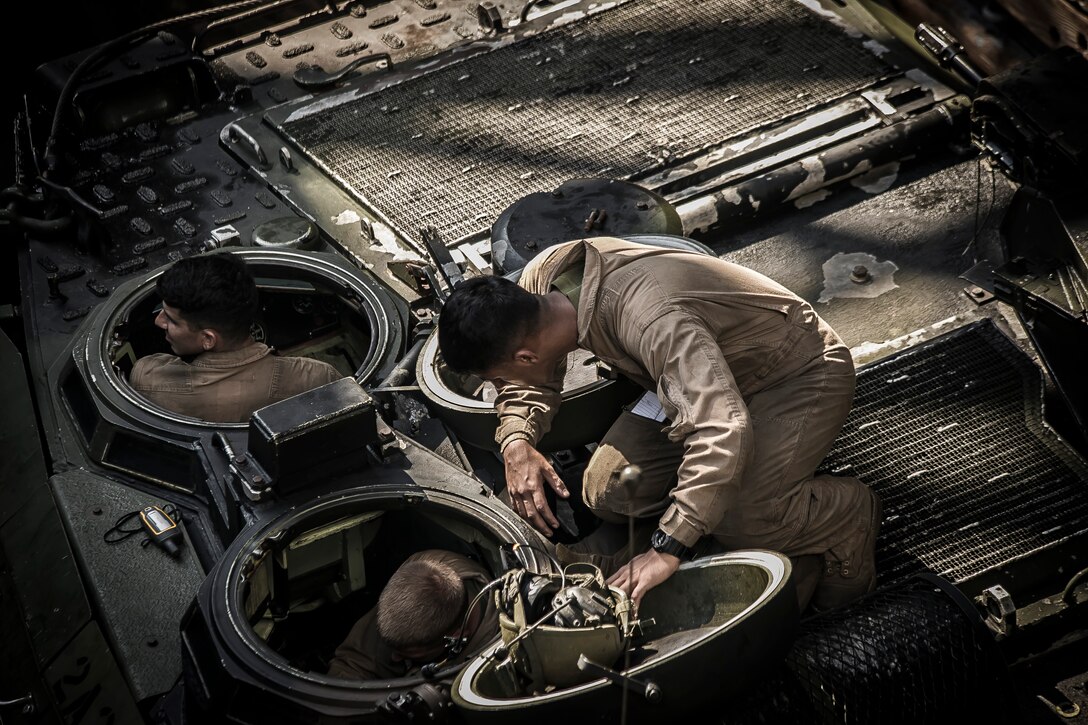 U.S. Marines with the Amphibious Assault Vehicle Platoon, Battalion Landing Team 2nd Battalion, 6th Marine Regiment, 26th Marine Expeditionary Unit (MEU) performs vehicle inspections prior to an amphibious raid rehearsal during Amphibious Squadron (PHIBRON)-MEU Training (PMINT) off the North Carolina coast, July 14, 2017. PMINT allows the Navy-Marine Corps team to improve interoperability and exercise the unique capabilities of the Amphibious Task Force. 