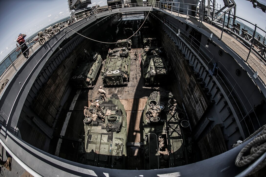 U.S. Marines with the Amphibious Assault Vehicle Platoon, Battalion Landing Team 2nd Battalion, 6th Marine Regiment, 26th Marine Expeditionary Unit (MEU) perform vehicle inspections prior to an amphibious raid rehearsal during Amphibious Squadron (PHIBRON)-MEU Training (PMINT) off the North Carolina coast, July 14, 2017. PMINT allows the Navy-Marine Corps team to improve interoperability and exercise the unique capabilities of the Amphibious Task Force. (U.S. Marine Corps Photo by Staff Sgt. Dengrier M. Baez/Released)