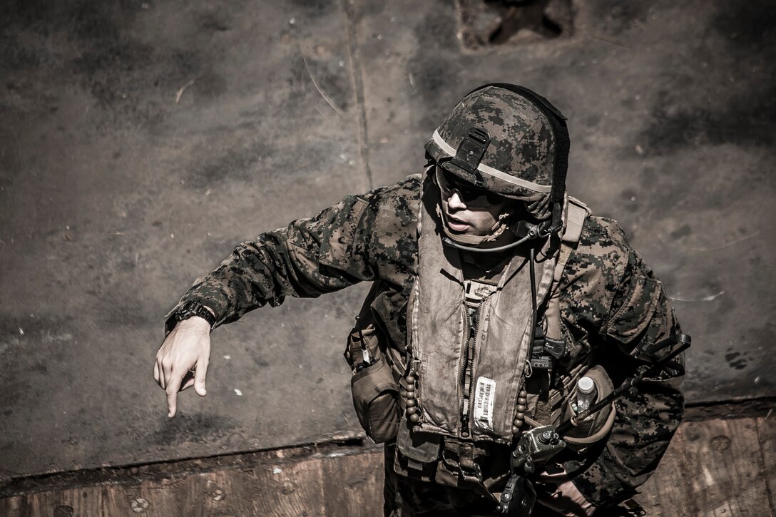 U.S. Marine 1st Lt. John M. Defelice, executive officer for Company F, Battalion Landing Team 2nd Battalion, 6th Marine Regiment, 26th Marine Expeditionary Unit (MEU) directs Marines prior to an amphibious raid rehearsal during Amphibious Squadron (PHIBRON)-MEU Training (PMINT) off the North Carolina coast, July 14, 2017. PMINT allows the Navy-Marine Corps team to improve interoperability and exercise the unique capabilities of the Amphibious Task Force. (U.S. Marine Corps Photo by Staff Sgt. Dengrier M. Baez/Released)