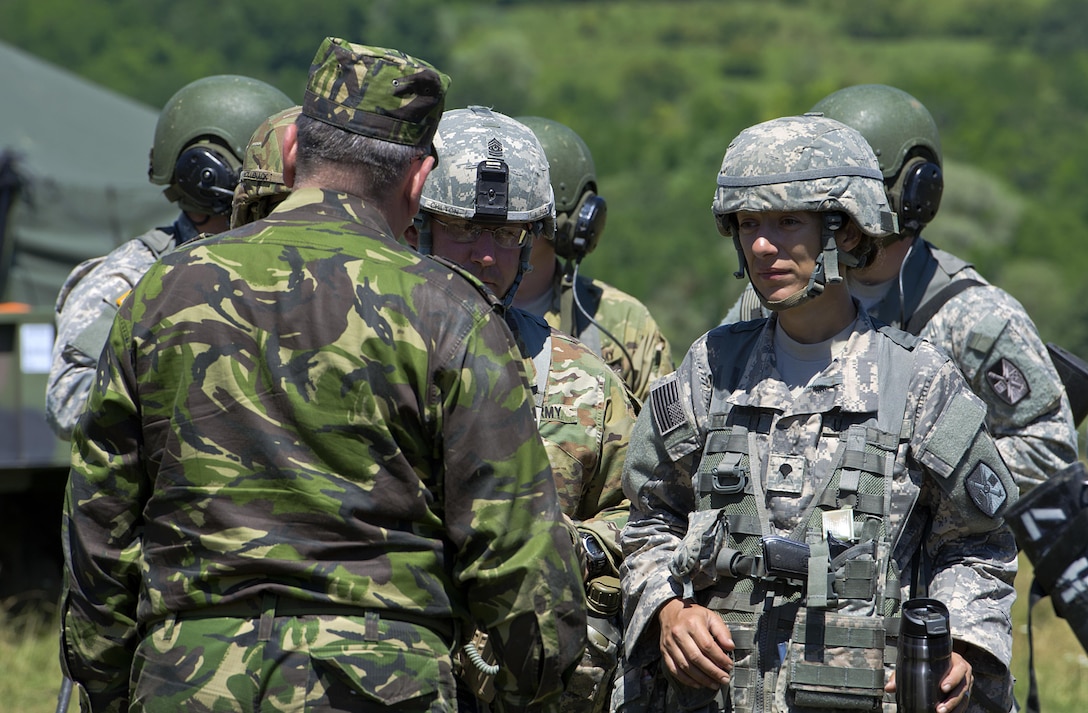 Army Spc. Gizela Lupescu translates for U.S. and Romanian soldiers during exercise Getica Saber 17 at the Joint National Training Center in Cincu, Romania, July 9, 2017. Lupescu immigrated from Romania in her twenties and joined the North Carolina Army National Guard as a combat medic specialist. Army photo by Sgt. Justin Geiger