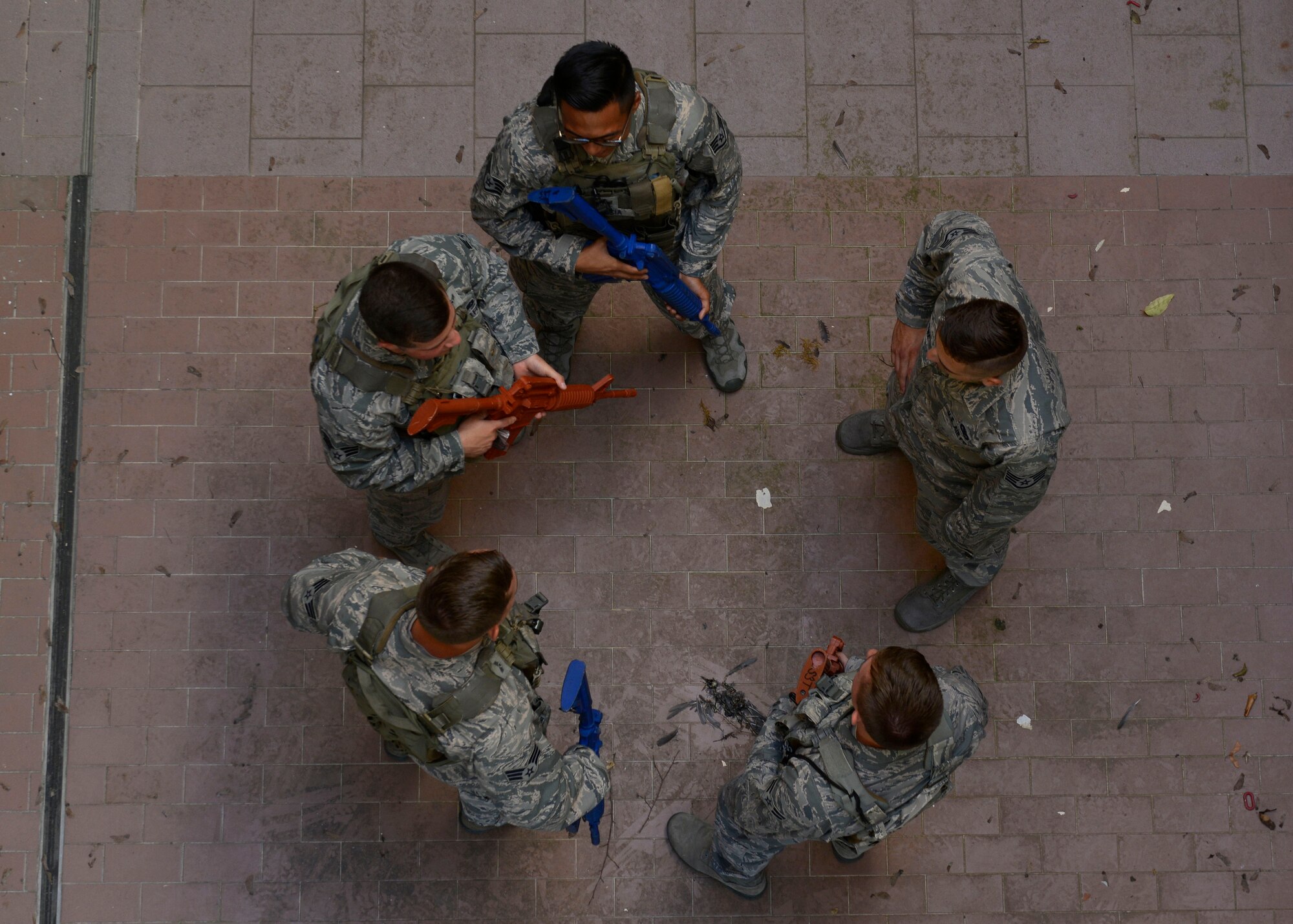 Airmen from the 31st Security Forces Squadron prepare to clear a room during close-quarters battle training, July 27, 2017, at Aviano Air Base, Italy. Approximately 50 defenders practiced clearing unoccupied buildings on base during simulated training scenarios involving hostage situations. (U.S. Air Force photo by Senior Airman Cary Smith)