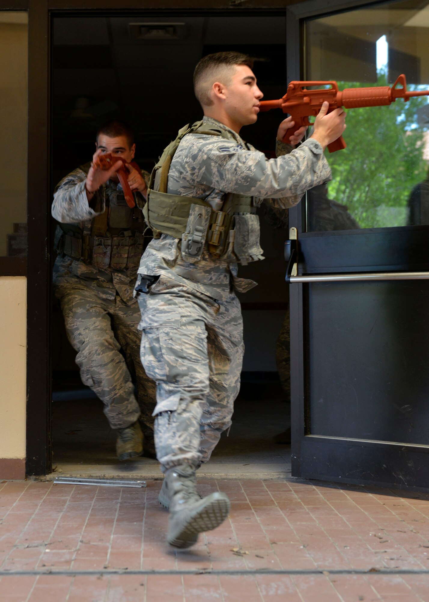 Airmen from the 31st Security Forces Squadron secure an outdoor area during close-quarters battle training, July 27, 2017, at Aviano Air Base, Italy. The hands-on training provided Airmen with an understanding of hostile, close-quarters environments in order to prepare for real-life scenarios. (U.S. Air Force photo by Senior Airman Cary Smith)