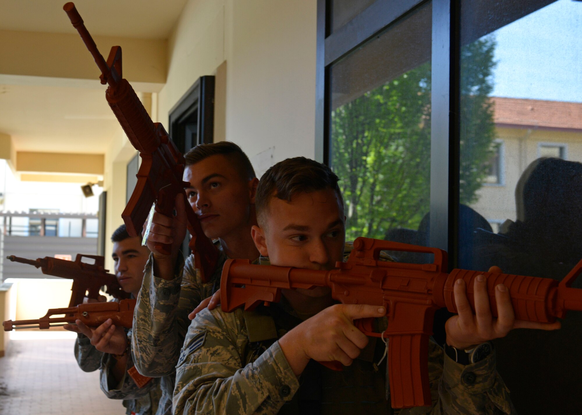 Airmen from the 31st Security Forces Squadron prepare to secure a room during close-quarters battle training, July 27, 2017, at Aviano Air Base, Italy. The defenders learned to work together in small teams to secure an area from enemy threats. (U.S. Air Force photo by Senior Airman Cary Smith)