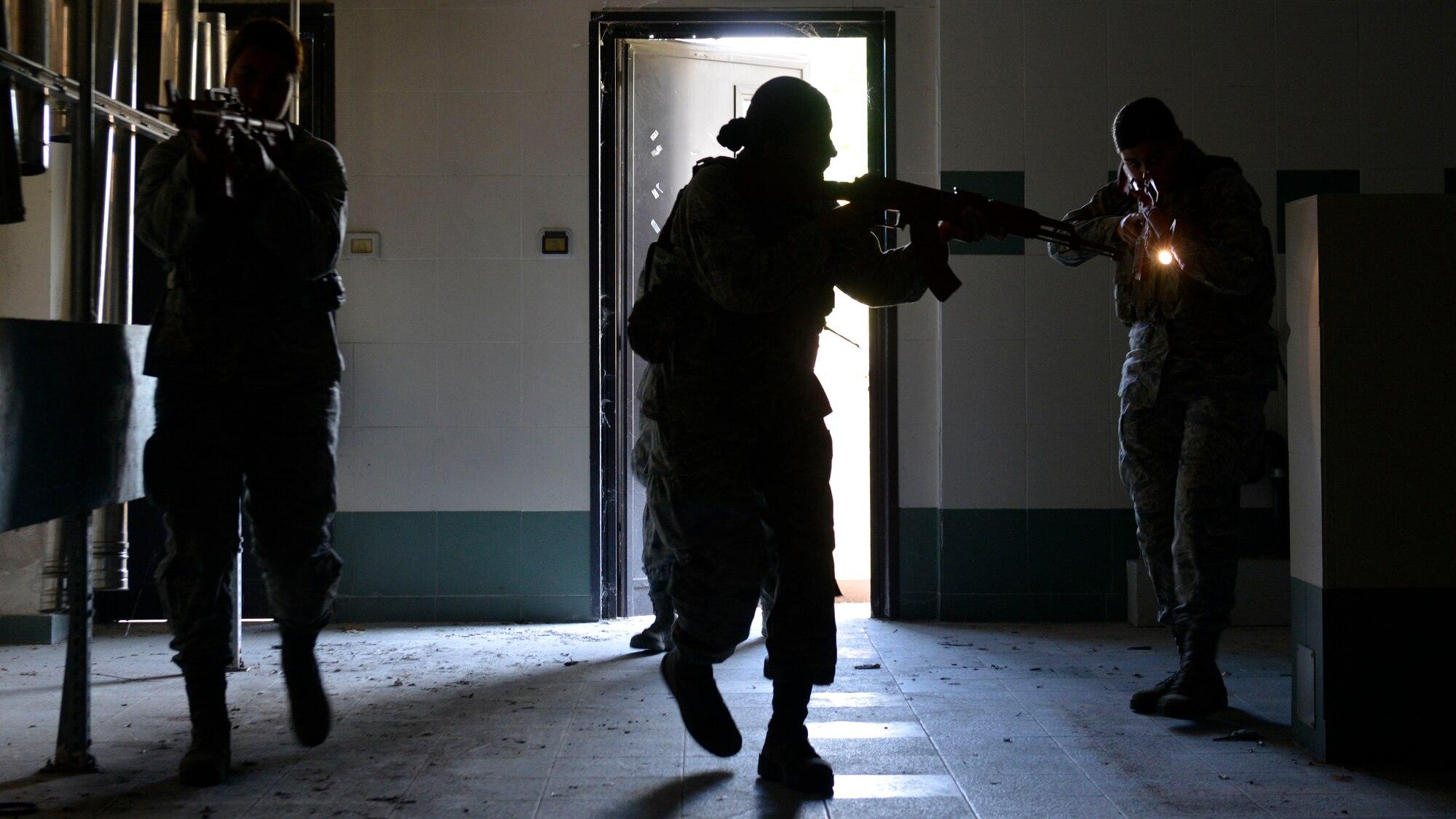 Airmen from the 31st Security Forces Squadron perform a security check in a room during close-quarters battle training, July 27, 2017, at Aviano Air Base, Italy. Approximately 50 defenders practiced clearing unoccupied buildings on base during simulated training scenarios involving hostage situations. (U.S. Air Force photo by Senior Airman Cary Smith)