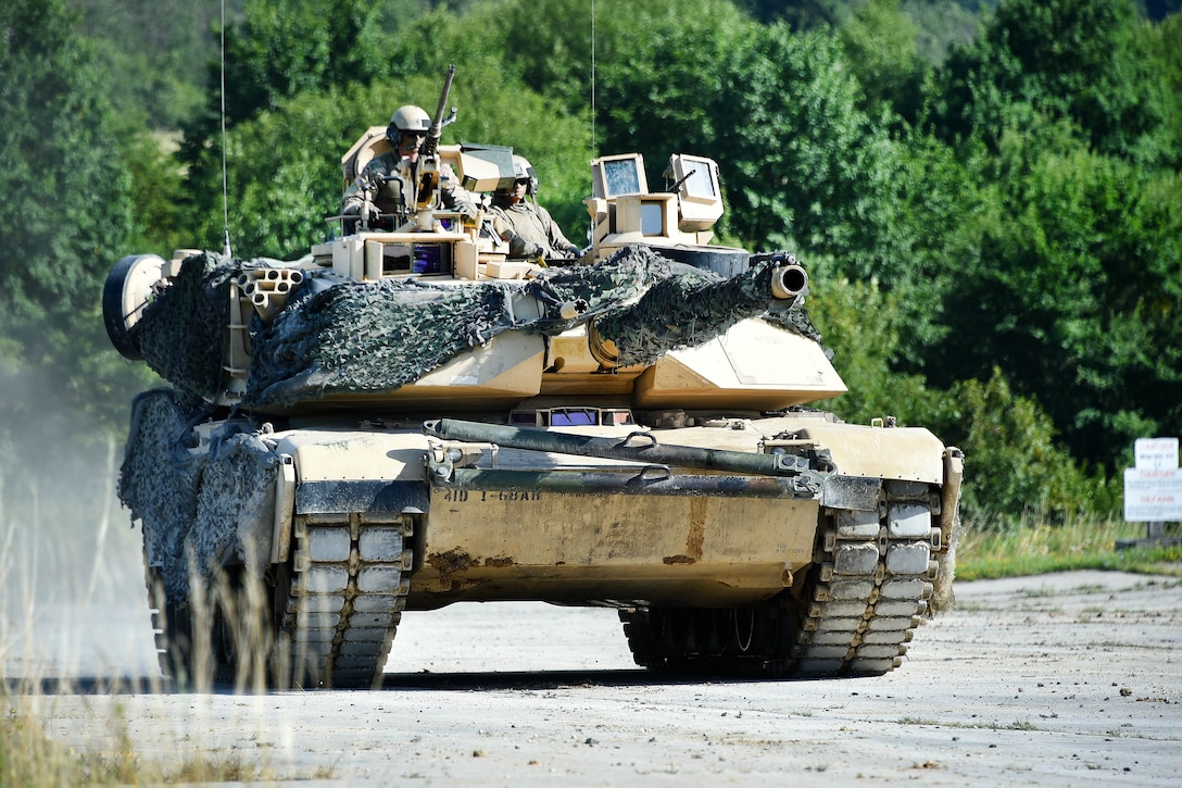 Soldiers move a tank into a firing position.