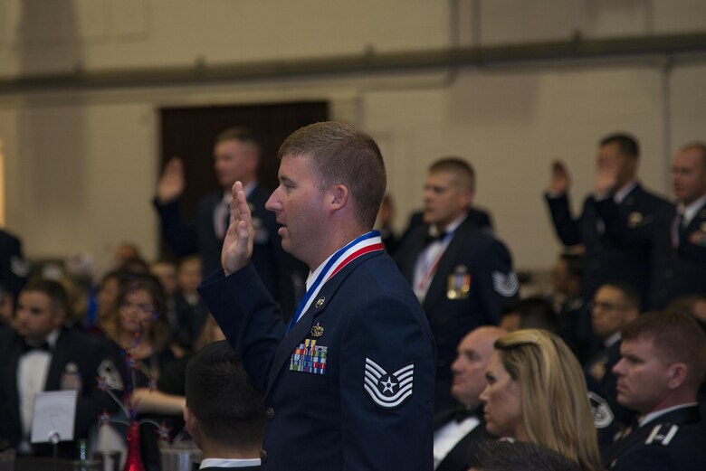 Airmen take an induction charge at a Senior NCO induction ceremony, July 28, 2017, at Moody Air Force Base, Ga. The event honored and celebrated the Airmen who have earned the rank of master sergeant. (U.S. Air Force photo by Airman 1st Class Erick Requadt)