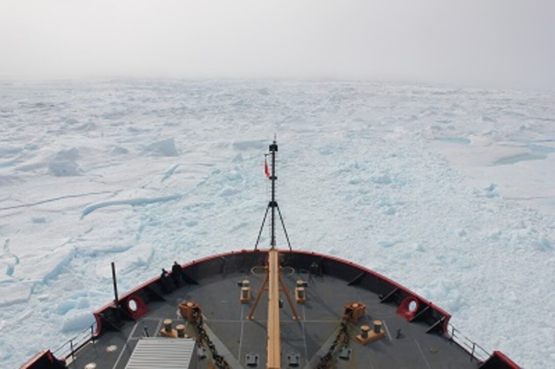 An icy landscape surrounds HEALY in the Arctic. 