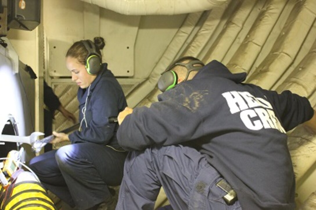 MK3 Danielle Ray performs maintenance the port rudder actuator. 