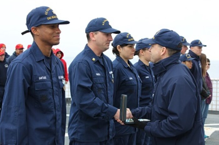 CAPT Hamilton presents SK1 Brian Purcell with the Arctic Service Medal.