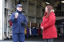 CAPT Hamilton receives the Infinity Globe from Michele Hoffman on behalf of the crew.