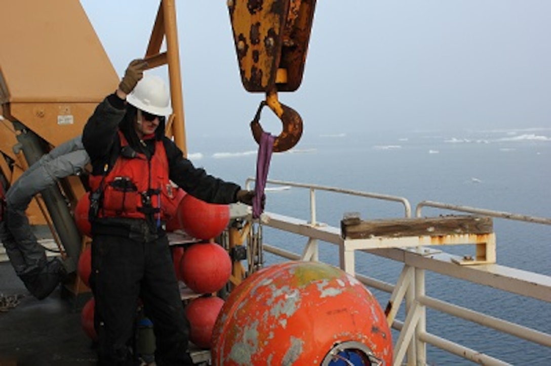 BM2 Jim Bowell prepares the mooring ball for redeployment.