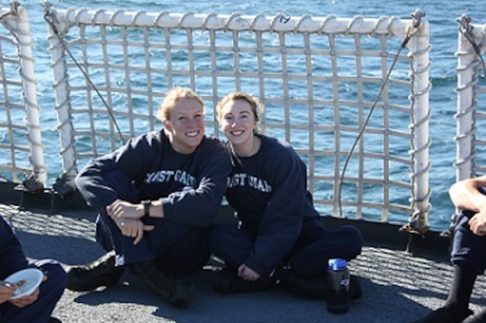 Cadets Susan West and Jennifer Haley soak up the sun on the flight deck.