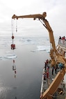 The HEALY crew recovers the mooring utilizing the starboard knuckle crane. 