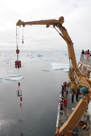 The HEALY crew recovers the mooring utilizing the starboard knuckle crane. 