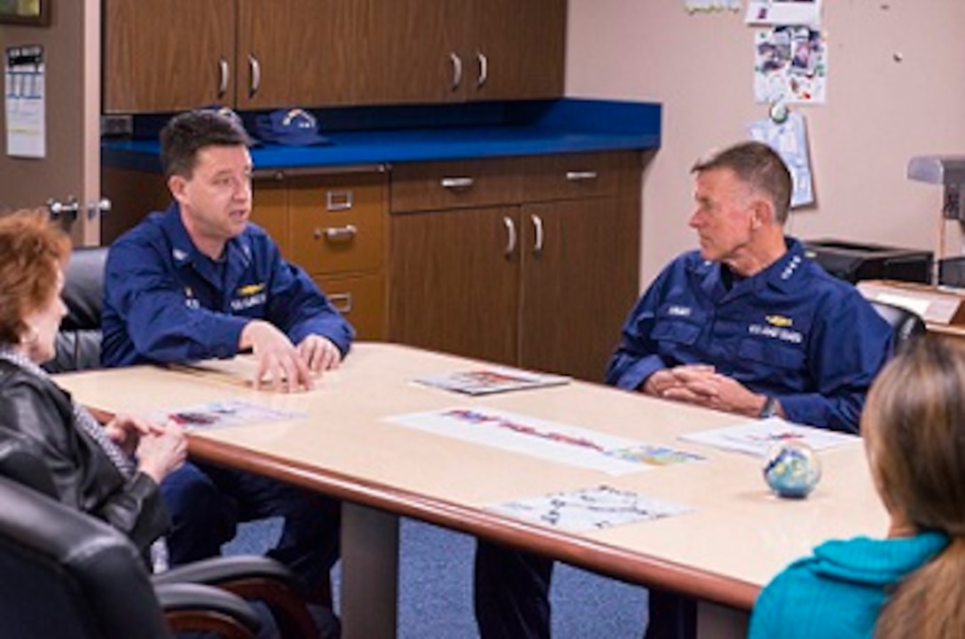ADM Paul Zukunft and CAPT Jason Hamilton speak with guests in the cabin.