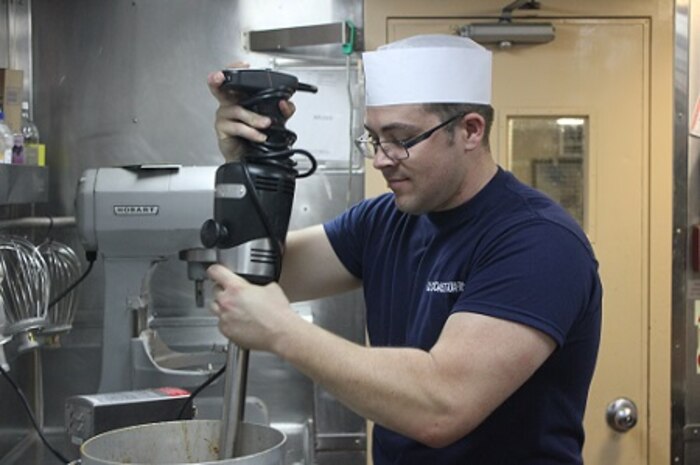 FS2 Ethan Sanders hard at work in the galley.