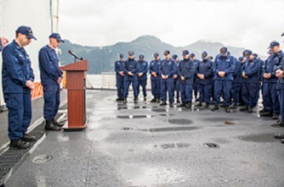 HEALY’s crew bows their heads for a moment of silence.