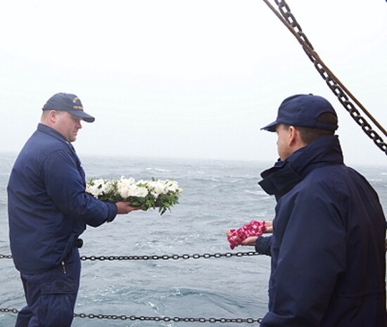 BMC Chris Lobherr holds a wreath before committing it to the deep.