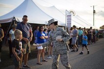 Senior Airman Karli Chaviano, 436th Aerospace Medicine Squadron, hands out Thunder Over Dover Open House flyers to parade spectators during the Delaware State Fair’s Military Appreciation Day parade July 26, 2017, in Harrington, Del. The Thunder Over Dover Open House will take place Aug. 26 - 27, 2017, on Dover Air Force Base, Del. (U.S. Air Force photo by Capt. Bernie Kale)