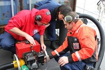 DCC Dave Warner instructs crewmembers on the use of the P-6 pump.