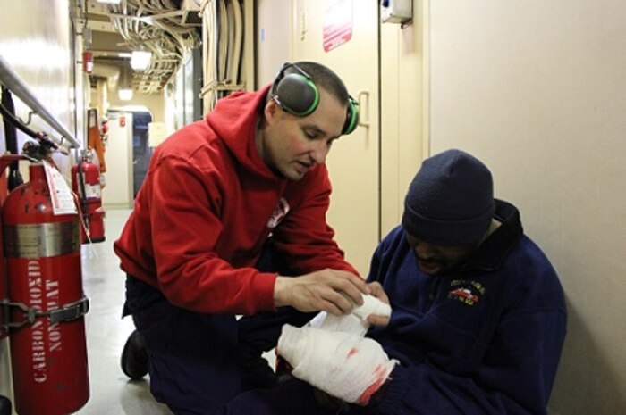 MK1 Nicholas Mersch practices administering first aid on SK2 Ronald Milton.