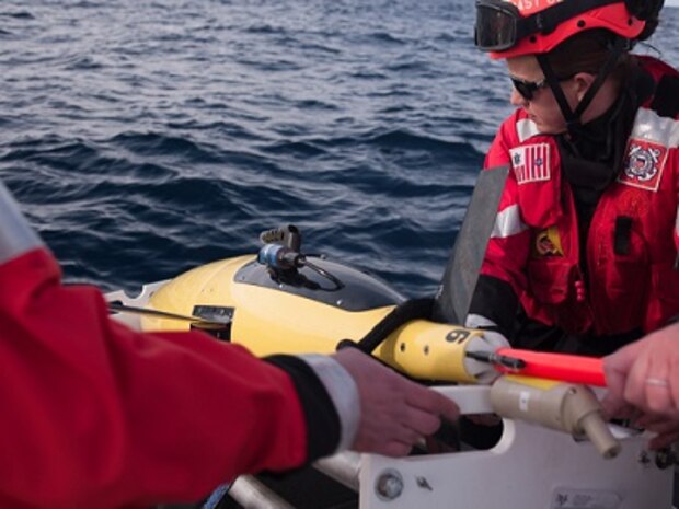 HEALY's small boat recovers one of the two Wave Gliders.