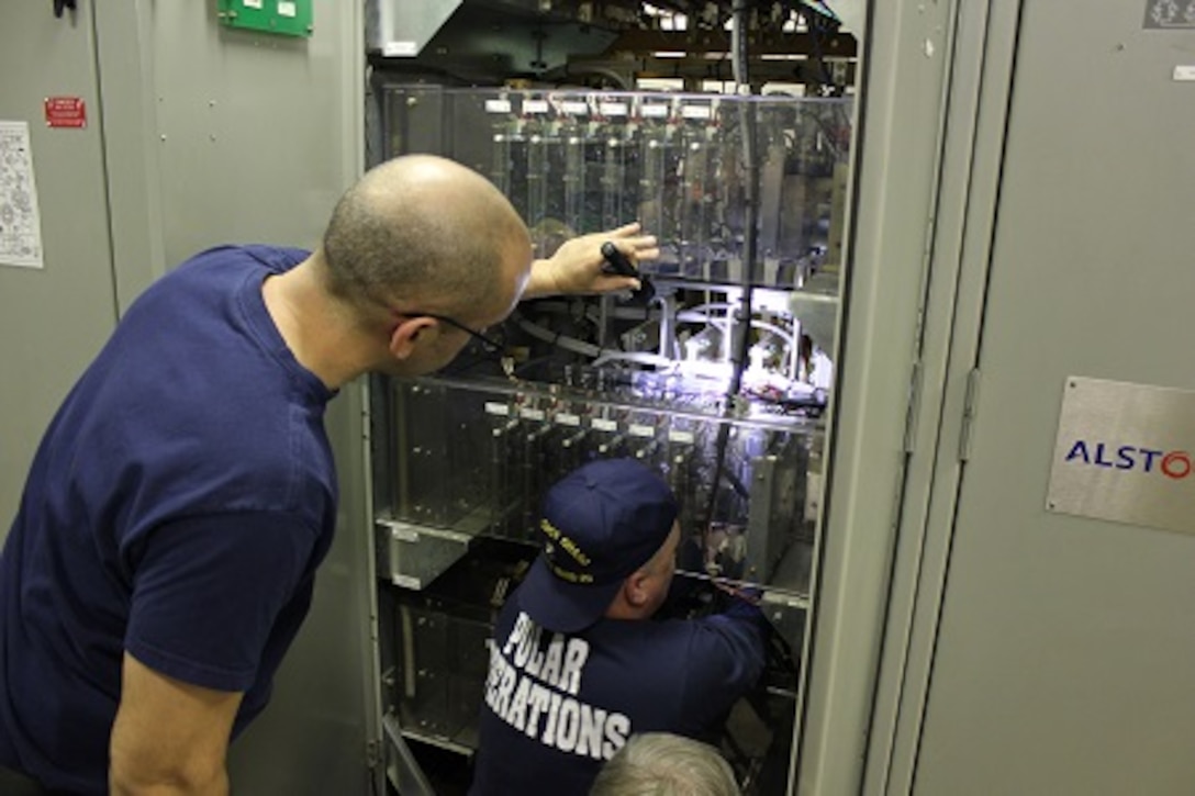EM1 Espinosa and EMCM Hudson replacing a cycloconverter circuit card. 