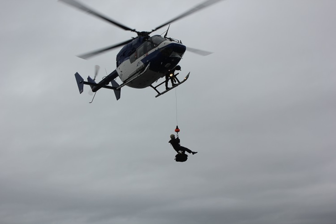 HEALY embarking the Inside Passage pilots via hoist operations.