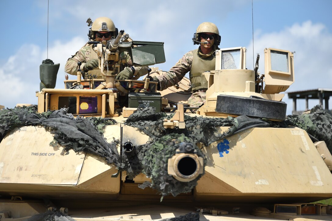 Soldiers return a tank to the motor pool after an exercise.
